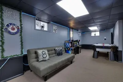a room with a couch and a ping pong table at The Playhouse Retreat Large Game Room Fire Pit in Tobyhanna