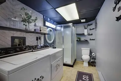a bathroom with a sink and a toilet at The Playhouse Retreat Large Game Room Fire Pit in Tobyhanna