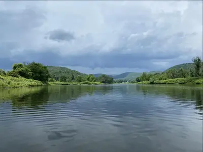 a view of a river with mountains in the background at Smith's Colonial Motel in Hancock