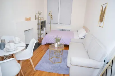 a living room with a white couch and a table at Stylish East Village Apartment12 close to Union Square Steps from NYC Best Restaurants & Shops in New York