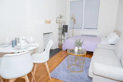 a living room with a couch and a table at Stylish East Village Apartment12 close to Union Square Steps from NYC Best Restaurants & Shops in New York