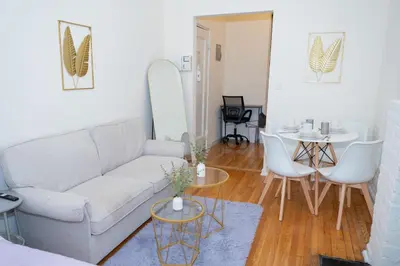 a living room with a couch and a table at Stylish East Village Apartment12 close to Union Square Steps from NYC Best Restaurants & Shops in New York