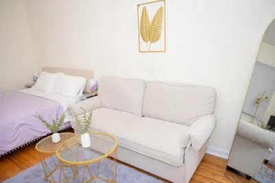 a living room with a couch and a bed at Stylish East Village Apartment12 close to Union Square Steps from NYC Best Restaurants & Shops in New York