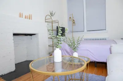 a living room with a glass table with two vases on it at Stylish East Village Apartment12 close to Union Square Steps from NYC Best Restaurants & Shops in New York