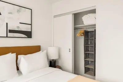 a bedroom with a bed and a closet at Blueground Midtown East rooftop nr Bryant Park NYC-2070 in New York