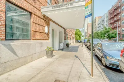 an umbrella on a sidewalk in front of a building at Blueground Lincoln Square fitness nr Central Park NYC-2102 in New York