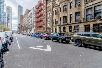 a row of cars parked on the side of a city street at Blueground Lincoln Square fitness nr Central Park NYC-2102 in New York