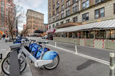 a group of bikes parked on a city street at Blueground Lincoln Square fitness nr Central Park NYC-2102 in New York