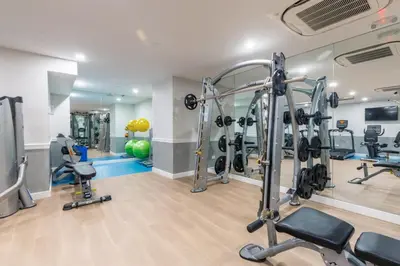 a gym with treadmills and weights in a room at Blueground Lincoln Square fitness nr Central Park NYC-2102 in New York