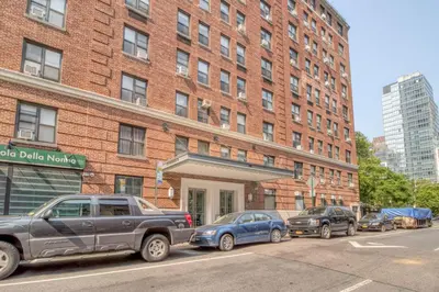 two cars parked in front of a brick building at Blueground Lincoln Square fitness nr Central Park NYC-2102 in New York