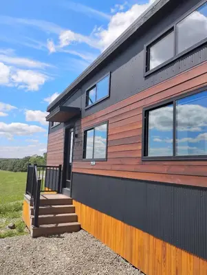 a modern home with a red and black exterior at Tioga Ridge Lookout I Near Tioga-Hammond Lake