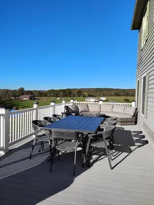 a patio with a table and chairs on a deck at 11-Acre Retreat I Firepit, Pickleball and Nature