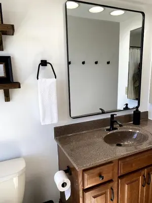 a bathroom with a sink and a mirror at 11-Acre Retreat I Firepit, Pickleball and Nature