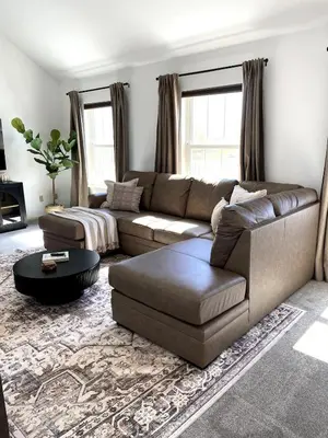a living room with a couch and a coffee table at 11-Acre Retreat I Firepit, Pickleball and Nature