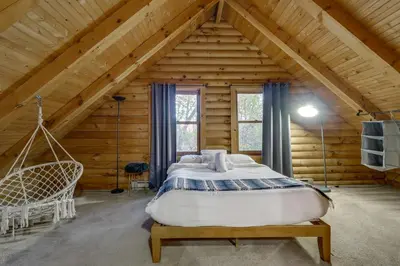 a bedroom with a large bed in a wooden house at Year-Round Outdoor Adventures Poconos Hideaway in East Stroudsburg