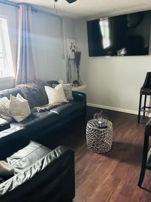 a living room with a couch and a tv at The Layover Lounge in Elizabeth