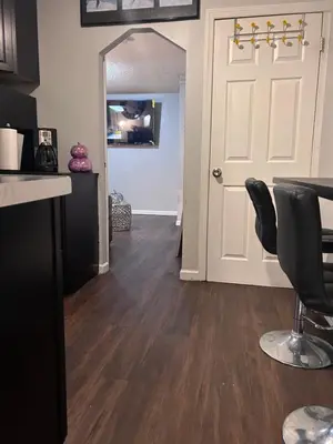 a living room with a door and a table and chairs at The Layover Lounge in Elizabeth