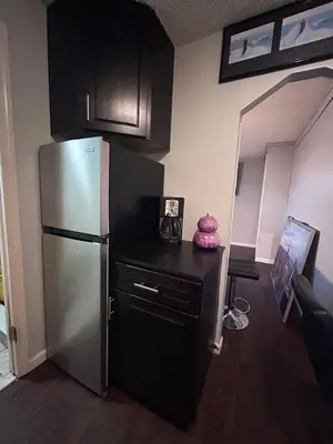 a kitchen with a stainless steel refrigerator in a room at The Layover Lounge in Elizabeth