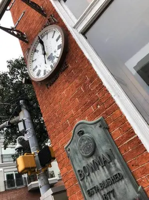 a clock on the side of a brick building with a sign at THE WINTER HOUSE - HISTORIC DOWNTOWN LANCASTER in Lancaster