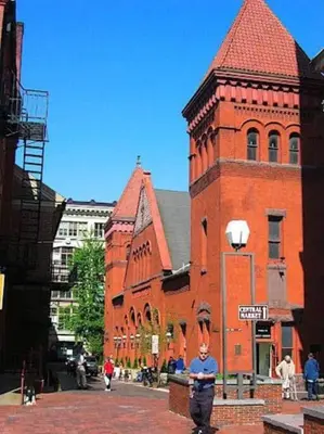 a man standing in front of a red brick building at THE WINTER HOUSE - HISTORIC DOWNTOWN LANCASTER in Lancaster