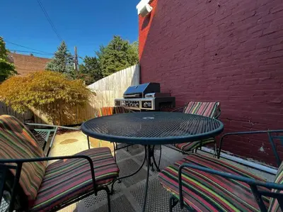 a patio with a table and chairs and a grill at THE WINTER HOUSE - HISTORIC DOWNTOWN LANCASTER in Lancaster
