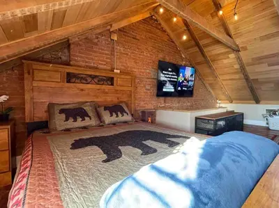 a bedroom with a large bed in a brick wall at THE LEMON TREE - DOWNTOWN HISTORIC LANCASTER in Lancaster