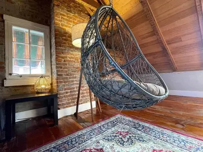 a hanging hammock in a room with a table at THE LEMON TREE - DOWNTOWN HISTORIC LANCASTER in Lancaster