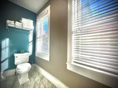 a bathroom with a white toilet and a window at THE STAGE HOUSE - CITY CENTER THEATER DISTRICT in Lancaster