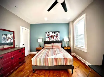 a bedroom with a bed and a dresser at THE STAGE HOUSE - CITY CENTER THEATER DISTRICT in Lancaster