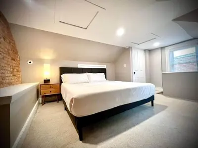 a bedroom with a large white bed and a window at THE STAGE HOUSE - CITY CENTER THEATER DISTRICT in Lancaster