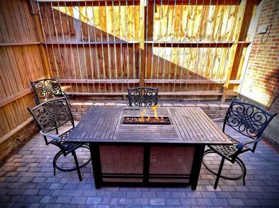 a wooden table and two chairs on a patio at THE STAGE HOUSE - CITY CENTER THEATER DISTRICT in Lancaster