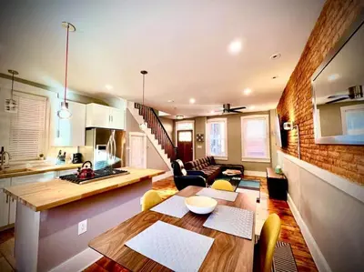 a kitchen and a living room with a table and chairs at THE STAGE HOUSE - CITY CENTER THEATER DISTRICT in Lancaster