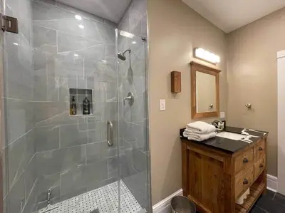 a bathroom with a glass shower with a sink at THE LIMÓNETTA - STUDIO IN HISTORIC LANCASTER in Lancaster