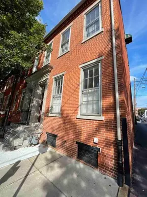 a red brick building with windows on a street at THE LIMÓNETTA - STUDIO IN HISTORIC LANCASTER in Lancaster