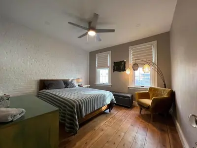 a bedroom with a bed and a ceiling fan at THE CONESTOGA HOUSE - THEATER & BUSINESS DISTRICT in Lancaster