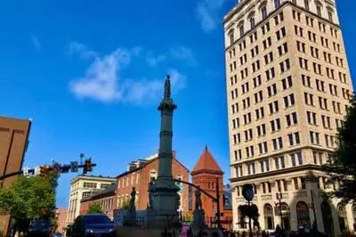 a city street with buildings and a monument in the middle at THE CONESTOGA HOUSE - THEATER & BUSINESS DISTRICT in Lancaster