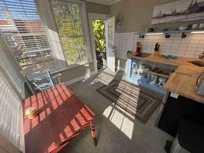 an aerial view of a kitchen with a bench and a table at BLETCHER GARDEN LOFT - LANCASTER HISTORIC DISTRICT in Lancaster