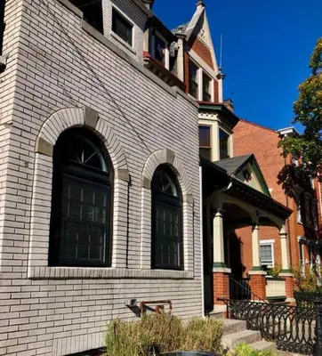 a white brick building with a large window at BLETCHER GARDEN LOFT - LANCASTER HISTORIC DISTRICT in Lancaster
