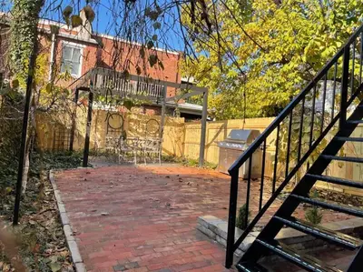 a brick walkway leading to a building with a staircase at BLETCHER GARDEN LOFT - LANCASTER HISTORIC DISTRICT in Lancaster