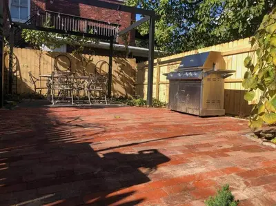 a patio with a grill and a table and chairs at BLETCHER GARDEN LOFT - LANCASTER HISTORIC DISTRICT in Lancaster