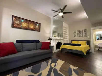 a living room with a couch and a bed at THE STEVENS STUDIO - HISTORIC DOWNTOWN LANCASTER in Lancaster