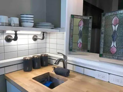 a kitchen with a sink and stained glass windows at THE STEVENS STUDIO - HISTORIC DOWNTOWN LANCASTER in Lancaster