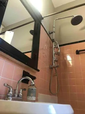 a shower in a bathroom with a sink and a mirror at THE STEVENS STUDIO - HISTORIC DOWNTOWN LANCASTER in Lancaster