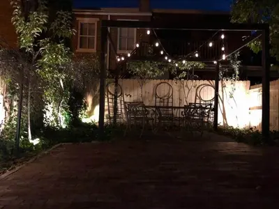 a group of chairs under a pergola with lights at THE STEVENS STUDIO - HISTORIC DOWNTOWN LANCASTER in Lancaster