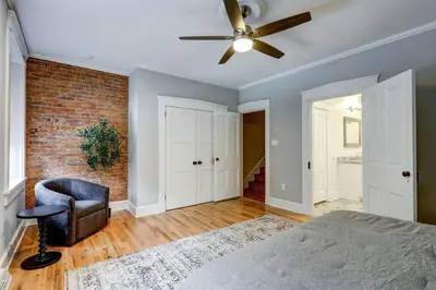 a bedroom with a ceiling fan and a chair at THE HAMILTON HOUSE - DOWNTOWN COLONIAL LANCASTER in Lancaster