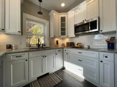 a white kitchen with white cabinets and a window at THE ROYER HOUSE - LANCASTER'S HISTORIC DISTRICT in Lancaster