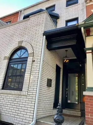 a white brick house with a front door and a window at THE ROYER HOUSE - LANCASTER'S HISTORIC DISTRICT in Lancaster