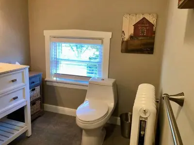 a bathroom with a white toilet and a window at THE ROYER HOUSE - LANCASTER'S HISTORIC DISTRICT in Lancaster