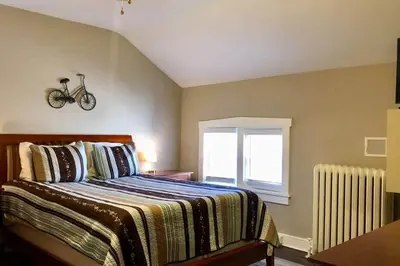 a bedroom with a bed with a bike on the wall at THE ROYER HOUSE - LANCASTER'S HISTORIC DISTRICT in Lancaster