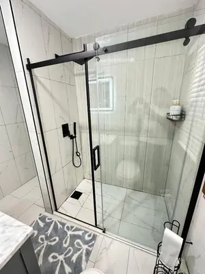 a shower with a glass door in a bathroom at Honesdale in Honesdale